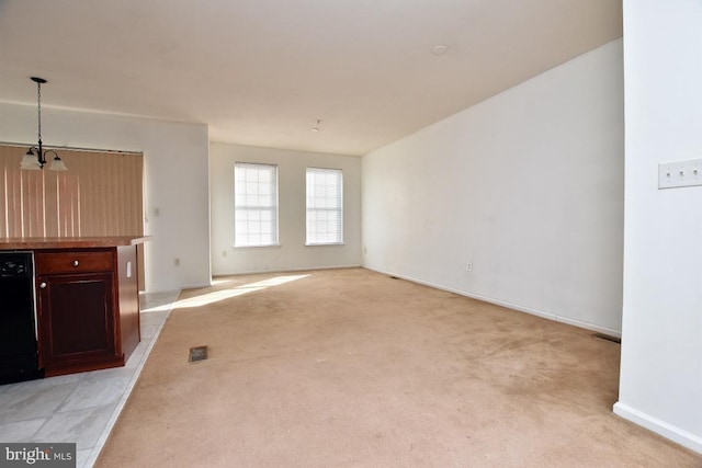 unfurnished living room with light carpet and an inviting chandelier