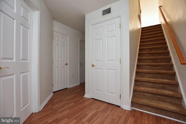 staircase featuring hardwood / wood-style floors