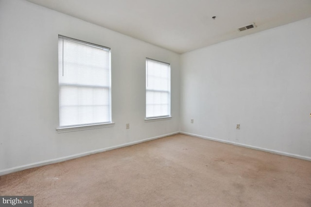 empty room featuring light colored carpet