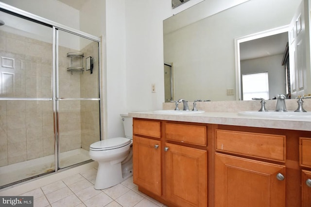 bathroom featuring tile patterned floors, vanity, an enclosed shower, and toilet