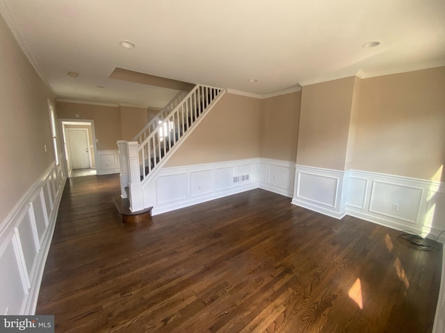 spare room with crown molding and dark hardwood / wood-style flooring