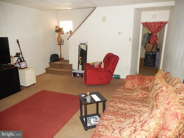 carpeted living room with a paneled ceiling