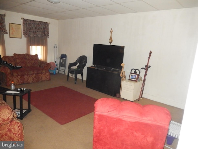 carpeted living room with a paneled ceiling