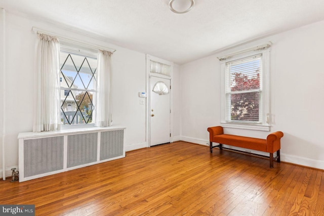 entryway with light wood-type flooring and radiator