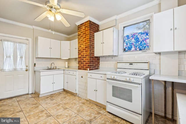 kitchen featuring ceiling fan, white cabinetry, sink, and gas range gas stove