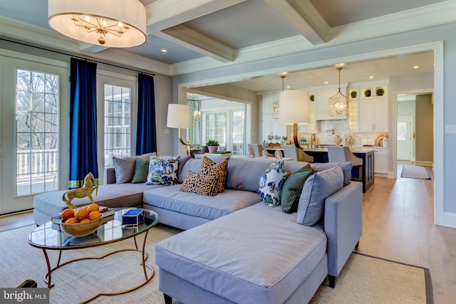 living room with light hardwood / wood-style floors, beamed ceiling, and crown molding