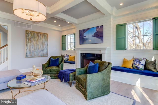 living room featuring wood-type flooring, beamed ceiling, crown molding, and coffered ceiling