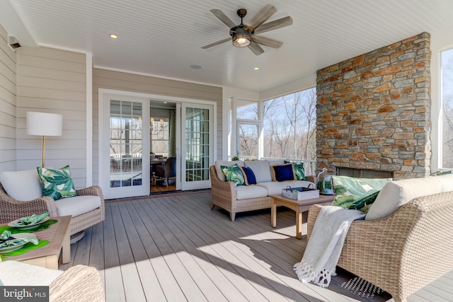 wooden deck featuring ceiling fan and outdoor lounge area