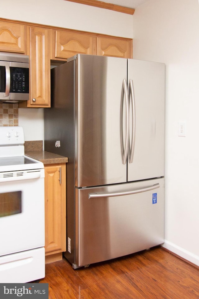 kitchen featuring light brown cabinets, backsplash, appliances with stainless steel finishes, and dark hardwood / wood-style floors