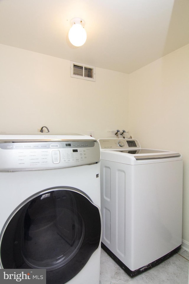 laundry area with separate washer and dryer