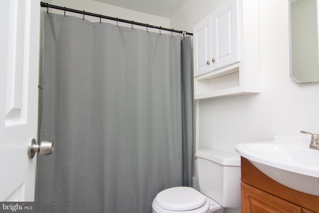 bathroom with vanity, toilet, and a shower with shower curtain