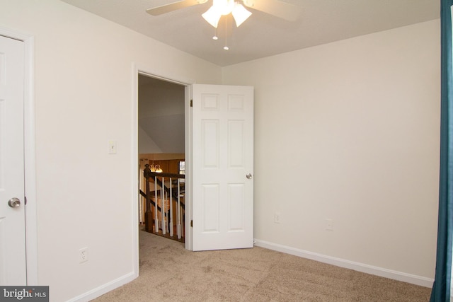 empty room featuring light carpet and ceiling fan