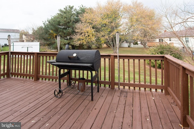 deck with grilling area and a lawn