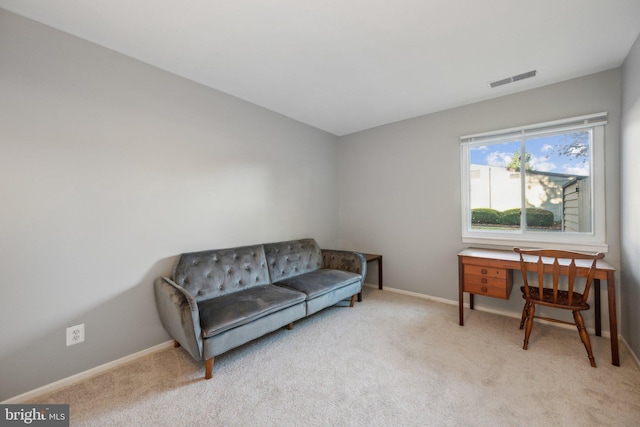 living area with light colored carpet