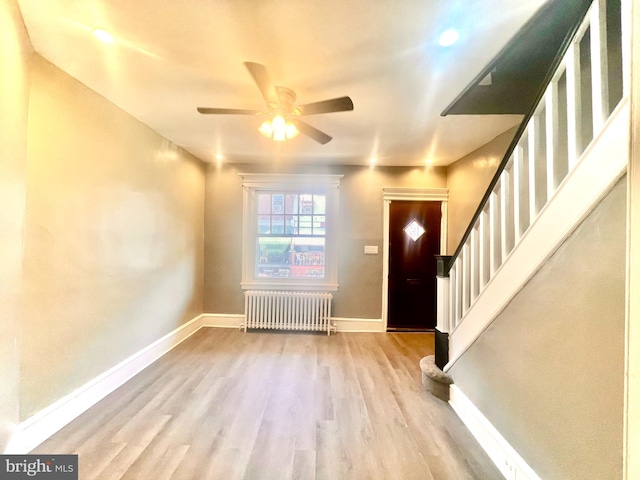 entryway with radiator heating unit, light hardwood / wood-style floors, and ceiling fan