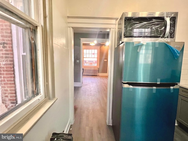 interior space with radiator and wood-type flooring