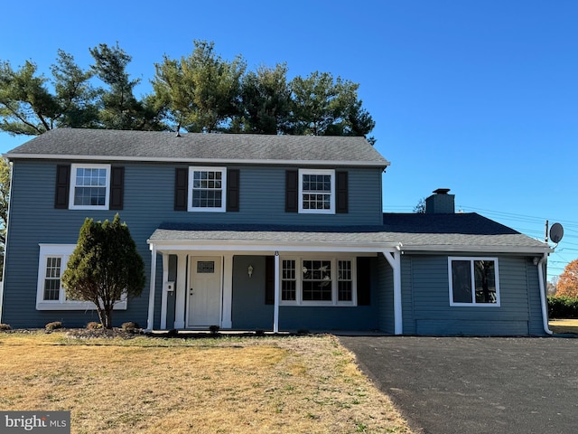 view of property with a front yard and a porch