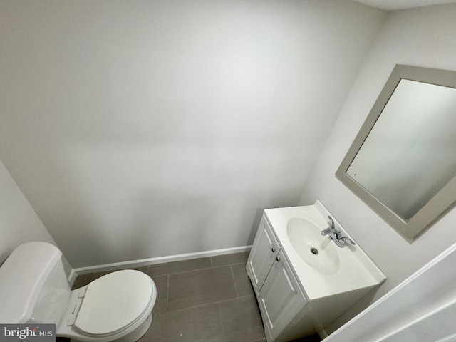 bathroom featuring tile patterned floors, vanity, and toilet