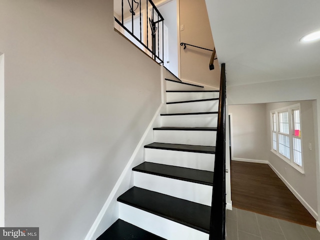 staircase with wood-type flooring