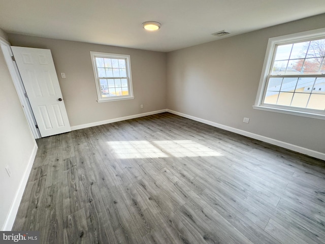 spare room with hardwood / wood-style floors