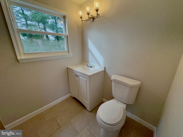 bathroom with tile patterned flooring, vanity, and toilet