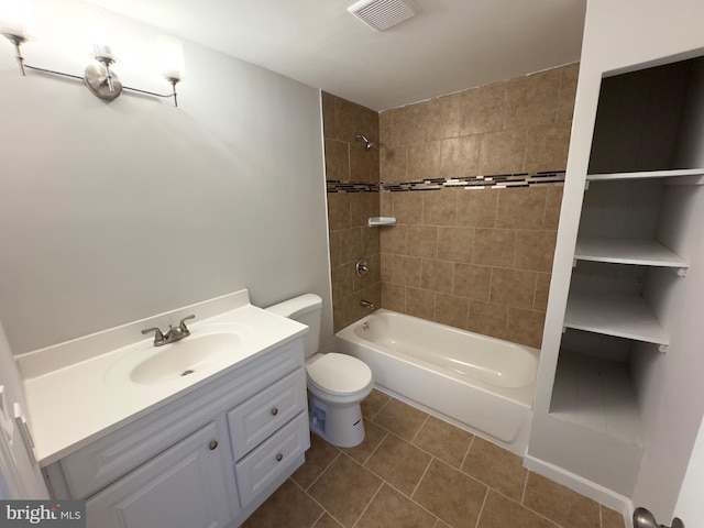 full bathroom with tile patterned flooring, vanity, toilet, and tiled shower / bath