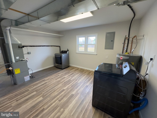 utility room featuring electric panel and water heater