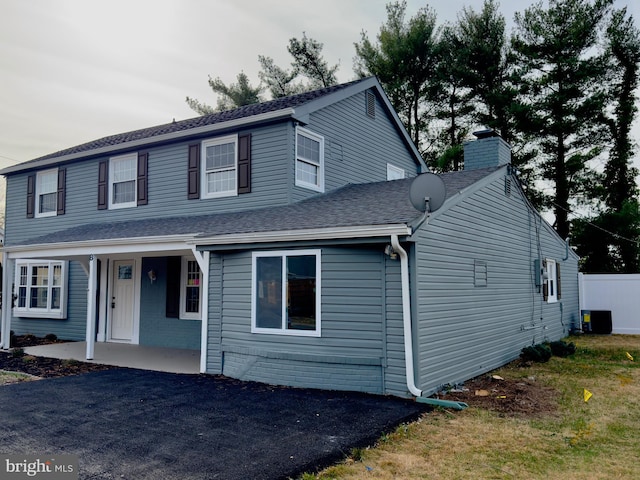 view of property with central AC unit and a patio