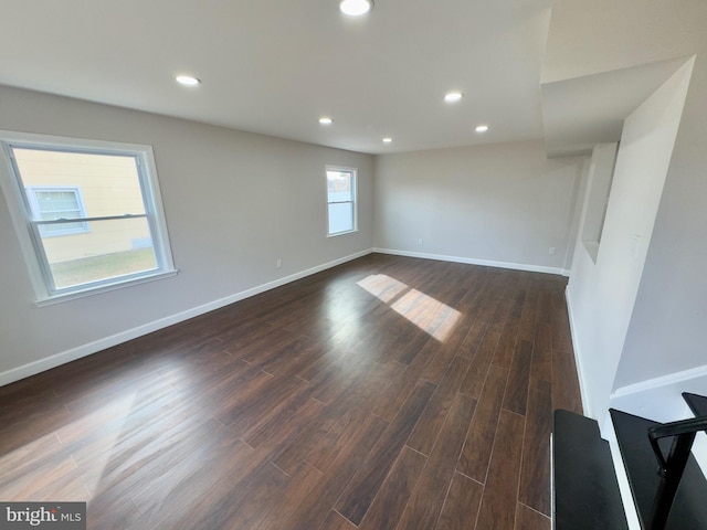 empty room with dark hardwood / wood-style flooring