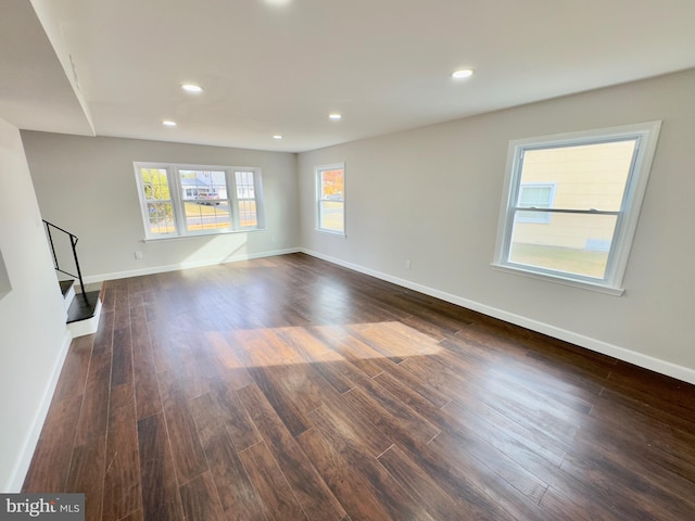 unfurnished living room with dark hardwood / wood-style flooring