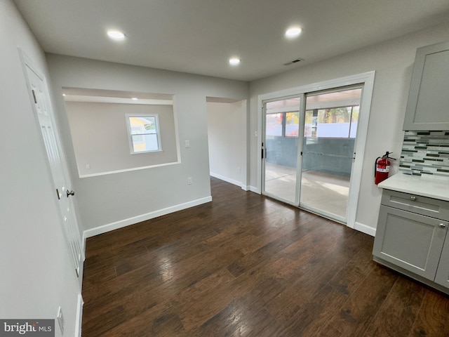 interior space with a healthy amount of sunlight and dark hardwood / wood-style flooring