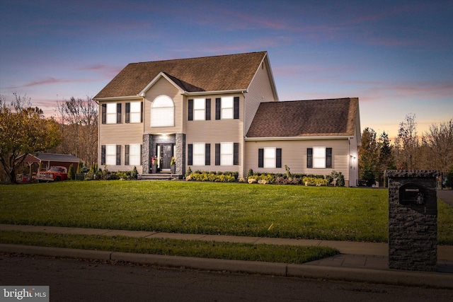 colonial-style house with a lawn