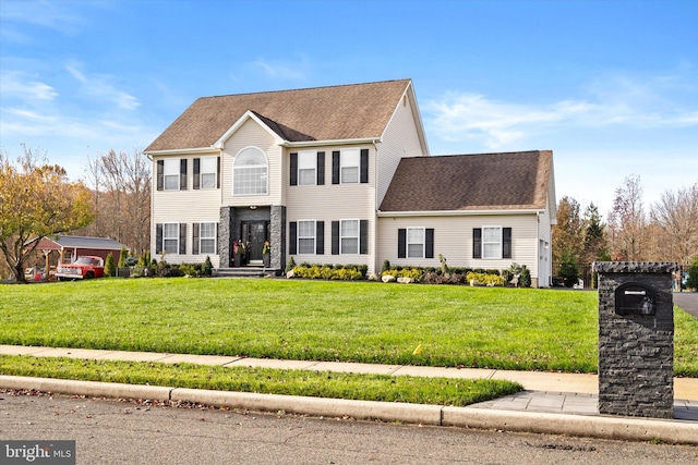 colonial home with a front lawn