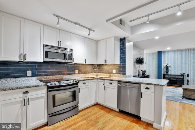 kitchen featuring white cabinetry, sink, and stainless steel appliances