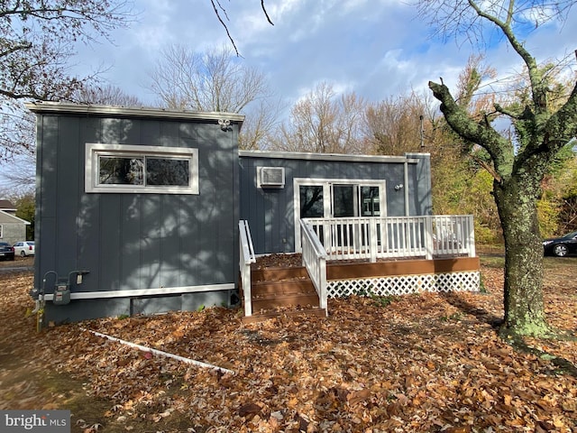 back of house featuring a wall mounted air conditioner