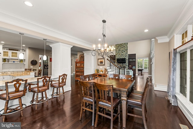 13105 Pendleton Ct, Reisterstown, MD 21136 - dining room featuring decorative columns, dark wood finished floors, recessed lighting, crown molding, and stairway