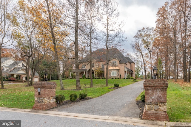 french provincial home featuring a front lawn