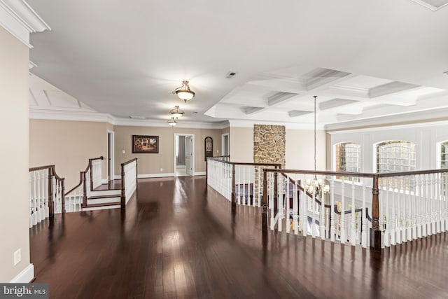 hall with dark wood-type flooring, beamed ceiling, crown molding, and coffered ceiling