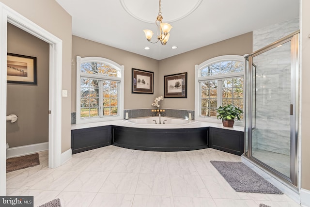 bathroom with plus walk in shower and an inviting chandelier