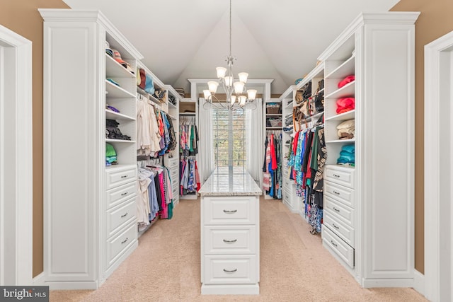 spacious closet featuring a notable chandelier, light carpet, and vaulted ceiling