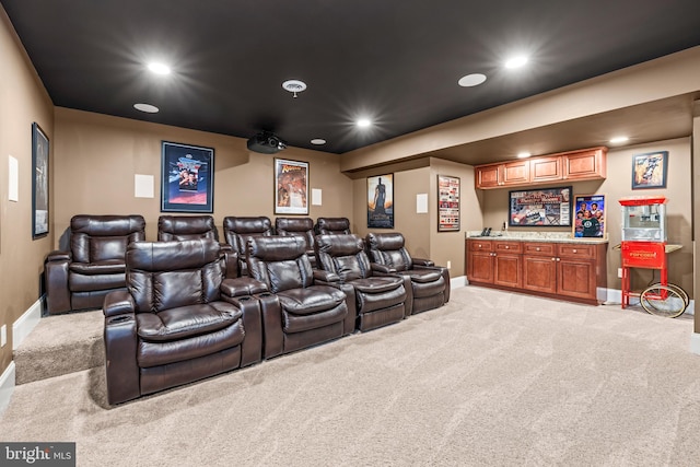 home theater with bar area and light colored carpet