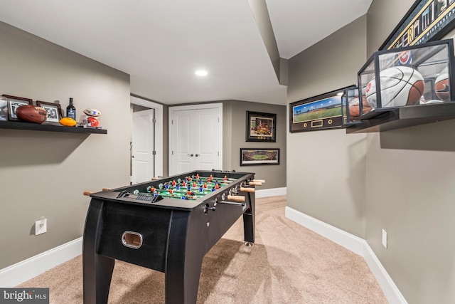 recreation room featuring light colored carpet