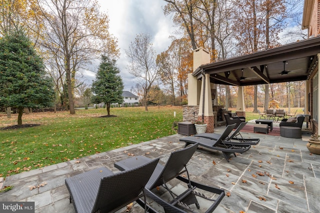 view of patio / terrace with an outdoor living space and ceiling fan