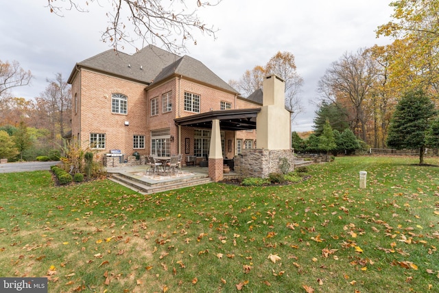 13105 Pendleton Ct, Reisterstown, MD 21136 - rear view of property featuring brick siding, a chimney, a yard, and a patio