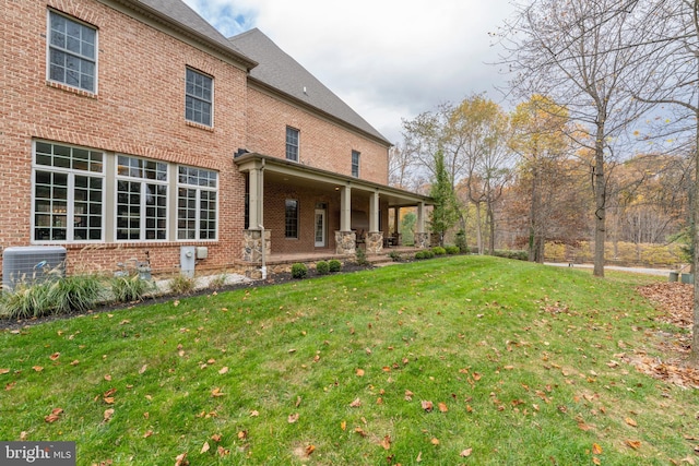 13105 Pendleton Ct, Reisterstown, MD 21136 - back of property with brick siding, a lawn, and central AC unit