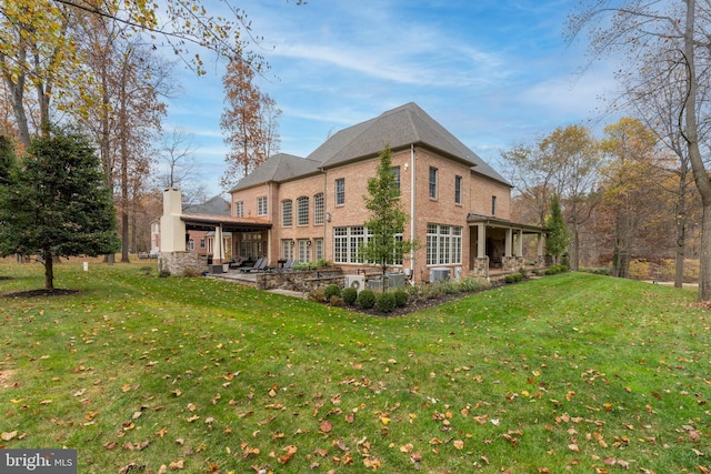 13105 Pendleton Ct, Reisterstown, MD 21136 - rear view of property with a patio, brick siding, a lawn, and a chimney