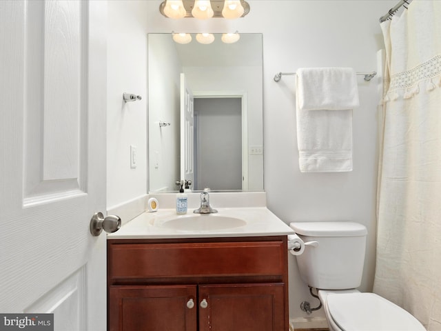 bathroom featuring vanity and toilet