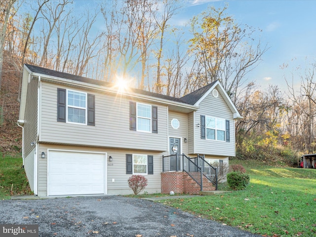 split foyer home with a front lawn and a garage