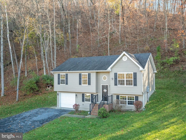 split foyer home with a garage and a front lawn