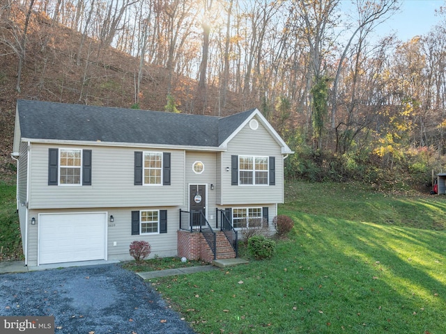 split foyer home with a front yard and a garage